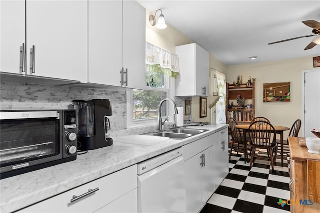 kitchen with dishwasher, sink, and white cabinets