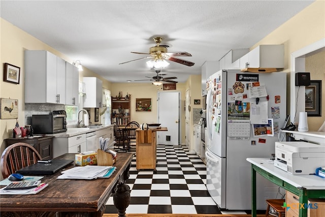 kitchen with sink, ceiling fan, a textured ceiling, white appliances, and white cabinets