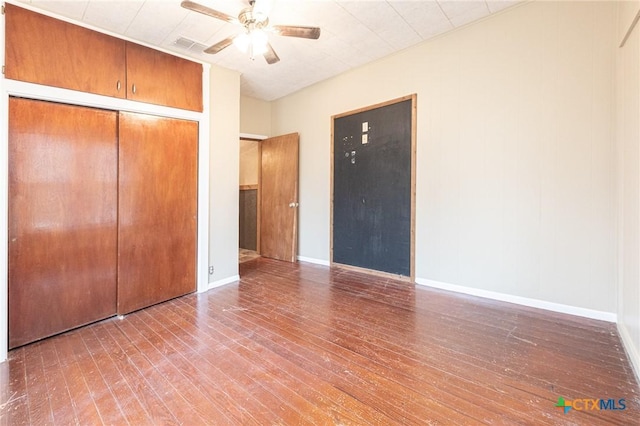 unfurnished bedroom featuring hardwood / wood-style flooring, a closet, and ceiling fan