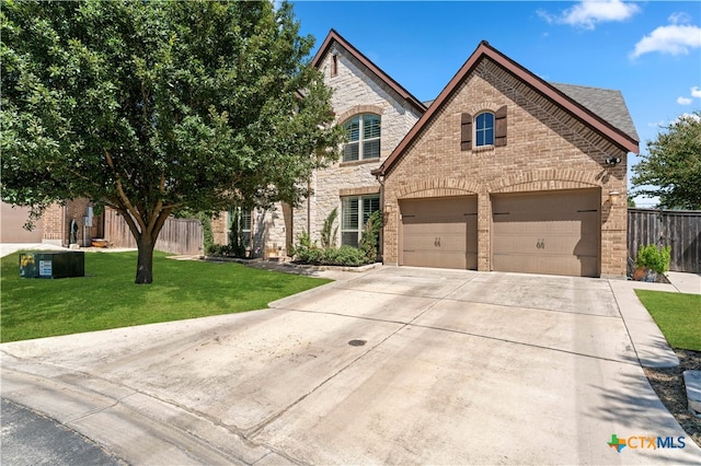 view of front of property featuring a front yard and a garage