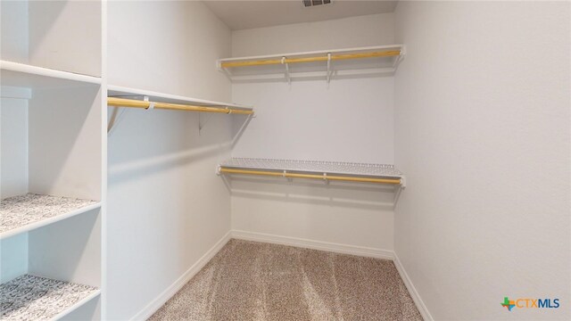 bedroom featuring ceiling fan, ensuite bathroom, vaulted ceiling, and light carpet