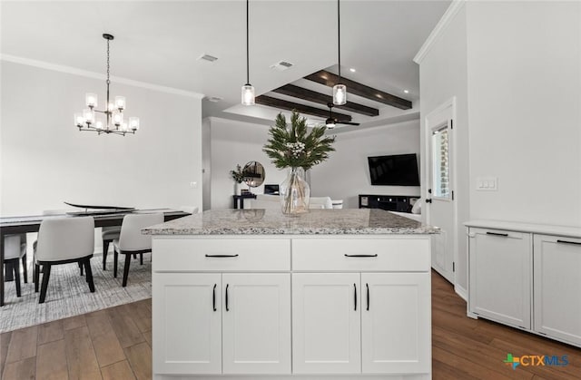 kitchen featuring visible vents, white cabinets, dark wood-style flooring, and decorative light fixtures