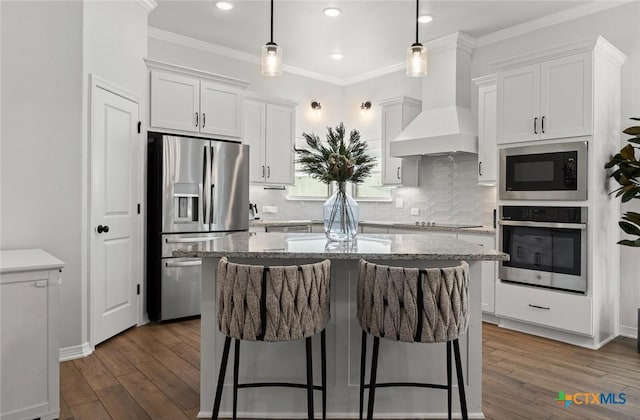 kitchen featuring stainless steel appliances, premium range hood, white cabinetry, a center island, and dark wood finished floors