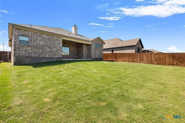 2027 Butternut Rd, Temple, TX 76502 - rear view of property with cooling unit, brick siding, and a chimney