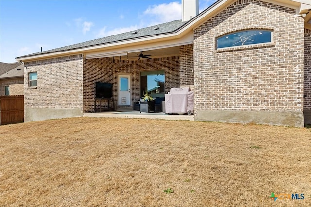 back of property featuring brick siding, a patio area, and a ceiling fan