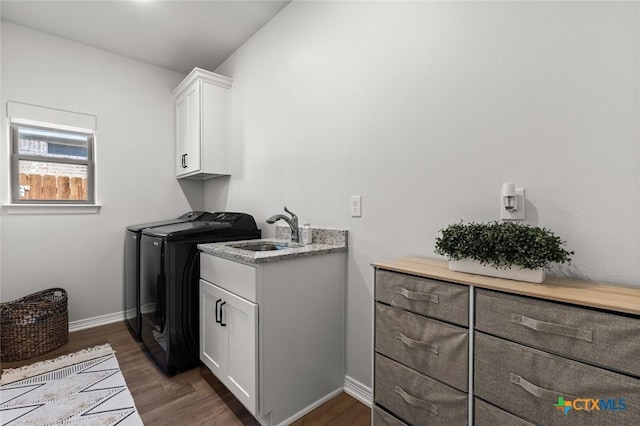 2027 Butternut Rd, Temple, TX 76502 - laundry room featuring cabinet space, washing machine and dryer, dark wood-style floors, and baseboards