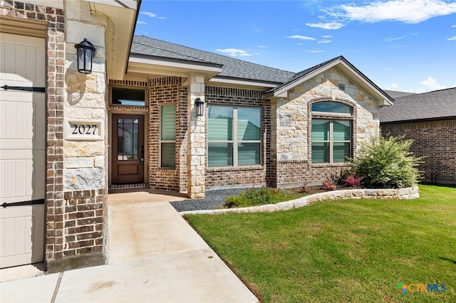 2027 Butternut Rd, Temple, TX 76502 - property entrance featuring a yard, brick siding, stone siding, and a shingled roof
