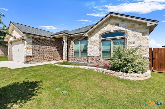 2027 Butternut Rd, Temple, TX 76502 - view of front of property with stone siding, an attached garage, concrete driveway, brick siding, and a shingled roof
