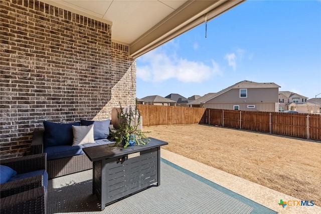 view of patio / terrace featuring a residential view, a fenced backyard, and an outdoor living space