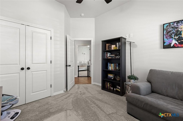 sitting room featuring carpet flooring, a ceiling fan, and baseboards