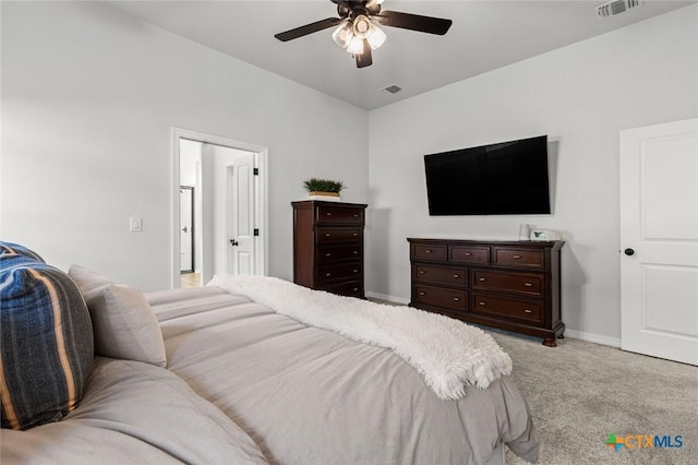 bedroom featuring baseboards, a ceiling fan, visible vents, and light colored carpet