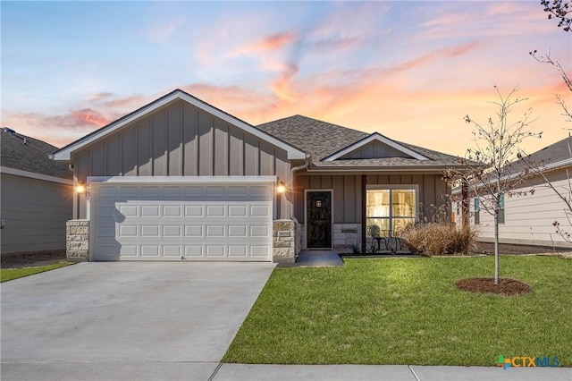 view of front of home featuring a garage and a lawn