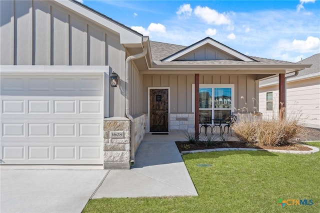 doorway to property featuring a porch, a yard, and a garage