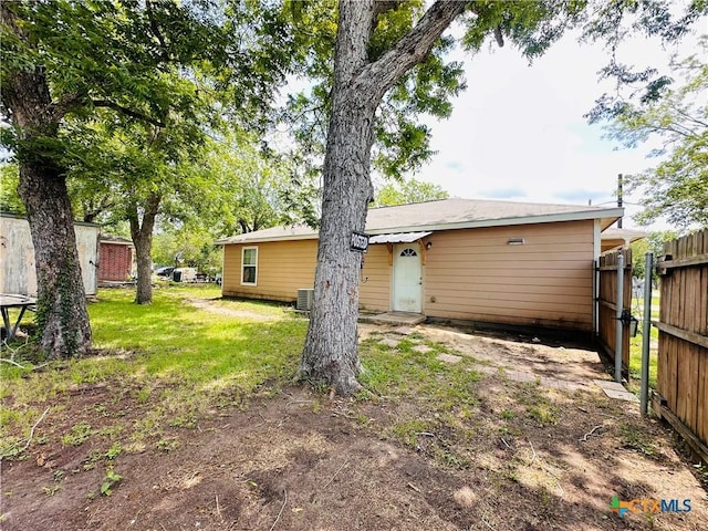 317 Aubrey St, Yoakum, TX 77995 - rear view of property featuring central AC unit