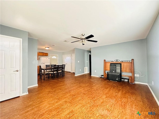 317 Aubrey St, Yoakum, TX 77995 - living area featuring wood finished floors, baseboards, and a ceiling fan