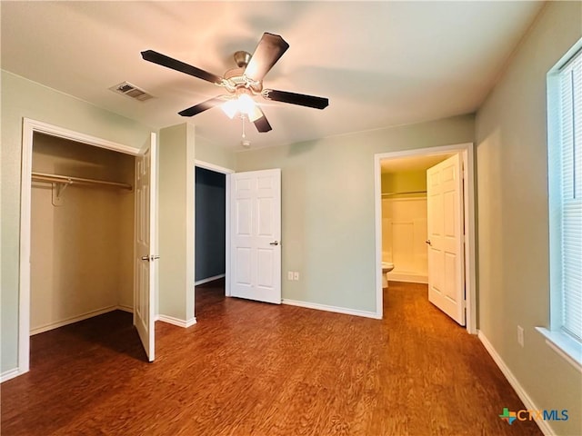 317 Aubrey St, Yoakum, TX 77995 - unfurnished bedroom with dark wood-style flooring, a closet, baseboards, and ceiling fan
