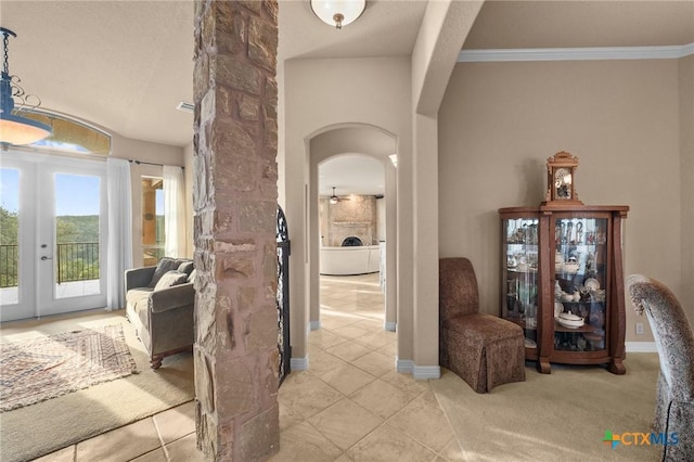 5310 River Oaks Dr, New Braunfels, TX 78132 - hall with arched walkways, french doors, light tile patterned flooring, and crown molding