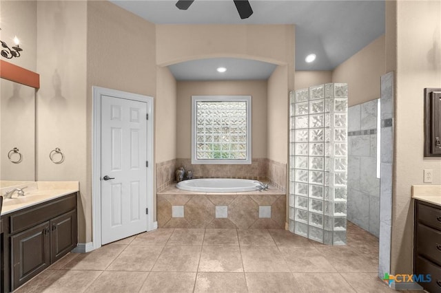 5310 River Oaks Dr, New Braunfels, TX 78132 - bathroom with vanity, ceiling fan, a walk in shower, a bath, and tile patterned floors