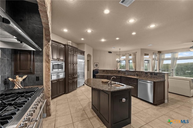 5310 River Oaks Dr, New Braunfels, TX 78132 - kitchen featuring built in appliances, a warming drawer, an island with sink, recessed lighting, and plenty of natural light