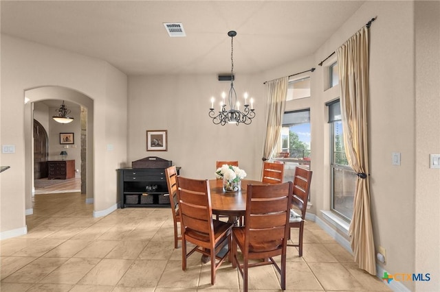 5310 River Oaks Dr, New Braunfels, TX 78132 - dining space featuring a chandelier, arched walkways, and light tile patterned floors