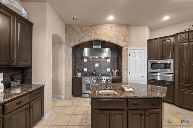 5310 River Oaks Dr, New Braunfels, TX 78132 - kitchen featuring wall chimney range hood, stainless steel appliances, a warming drawer, decorative backsplash, and light tile patterned floors