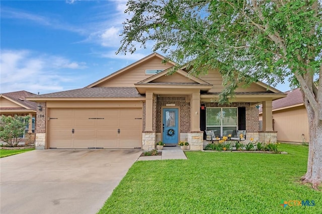106 Cobble Stone Ct, Victoria, TX 77904 - craftsman-style house featuring an attached garage, brick siding, driveway, a front lawn, and stone siding