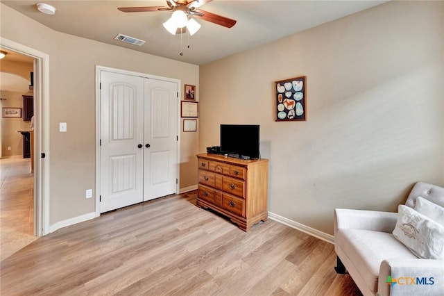 106 Cobble Stone Ct, Victoria, TX 77904 - living area with a ceiling fan, arched walkways, light wood-type flooring, and baseboards