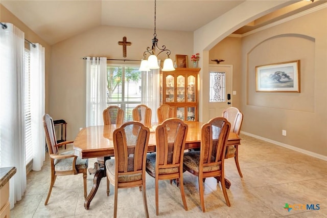 106 Cobble Stone Ct, Victoria, TX 77904 - dining room with a chandelier, light tile patterned flooring, vaulted ceiling, arched walkways, and baseboards