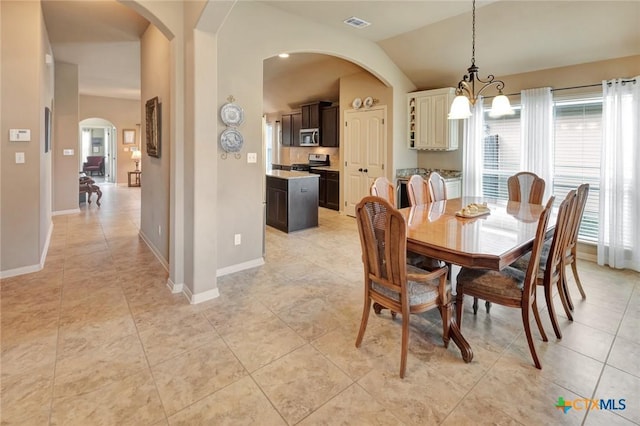 106 Cobble Stone Ct, Victoria, TX 77904 - dining space featuring arched walkways, a chandelier, light tile patterned floors, lofted ceiling, and baseboards