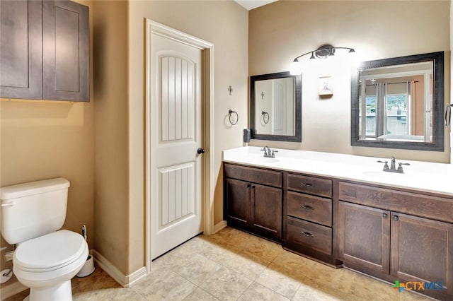 106 Cobble Stone Ct, Victoria, TX 77904 - bathroom with double vanity, toilet, baseboards, and tile patterned floors