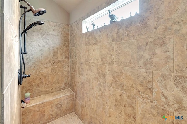 106 Cobble Stone Ct, Victoria, TX 77904 - bathroom featuring tiled shower and lofted ceiling