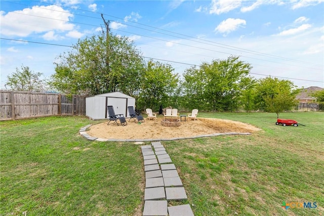 view of yard with an outdoor fire pit and a storage shed