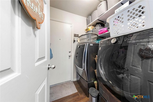 laundry area featuring independent washer and dryer and dark hardwood / wood-style floors