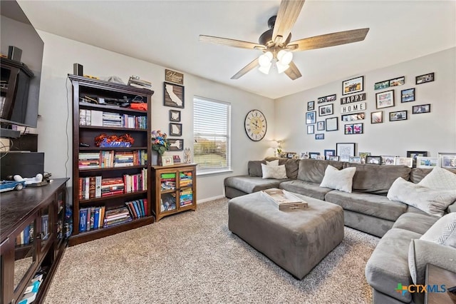 living room with ceiling fan and carpet