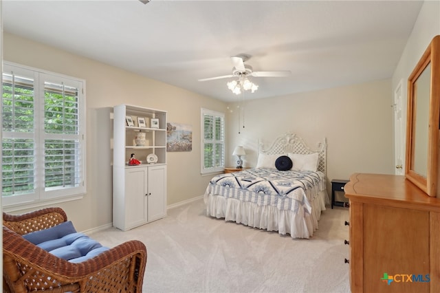 bedroom with baseboards, light carpet, and ceiling fan