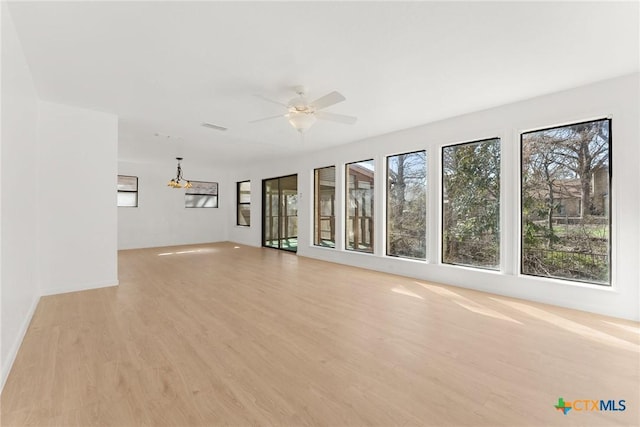 unfurnished living room with light wood-style flooring, visible vents, and ceiling fan