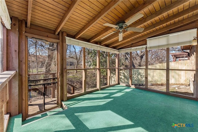 unfurnished sunroom featuring a ceiling fan, wooden ceiling, and vaulted ceiling with beams