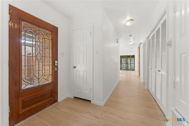 entryway featuring light wood-style flooring and baseboards