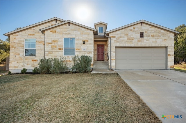 2803 American Dr, Lago Vista, TX 78645 - french country home featuring a front yard, driveway, stone siding, and a garage