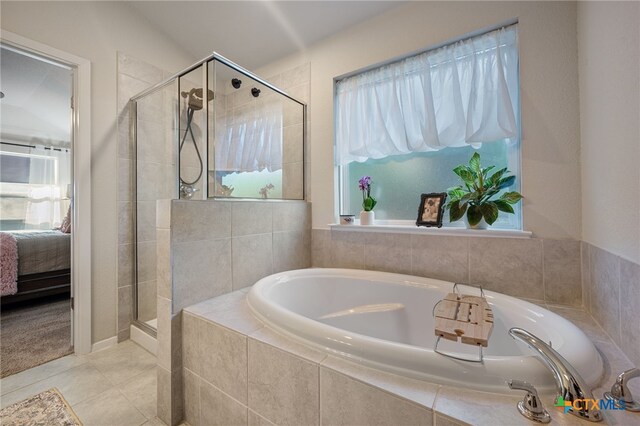 2803 American Dr, Lago Vista, TX 78645 - ensuite bathroom featuring tile patterned floors, ensuite bathroom, a shower stall, and a bath