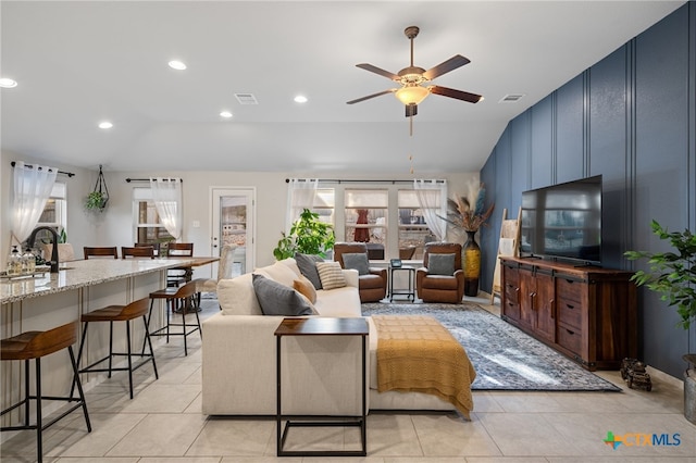 2803 American Dr, Lago Vista, TX 78645 - living room with ceiling fan, visible vents, light tile patterned floors, and lofted ceiling