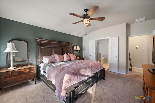 2803 American Dr, Lago Vista, TX 78645 - carpeted bedroom featuring a ceiling fan, connected bathroom, visible vents, baseboards, and lofted ceiling