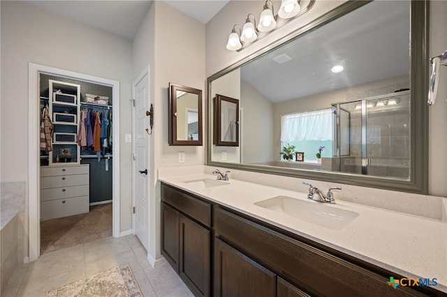 2803 American Dr, Lago Vista, TX 78645 - bathroom with a sink, a walk in closet, a stall shower, and tile patterned floors