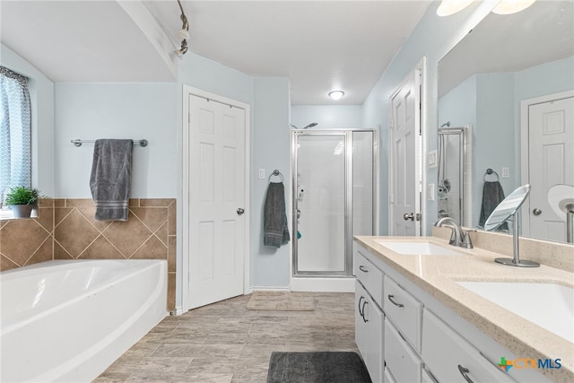 bathroom with vanity and separate shower and tub