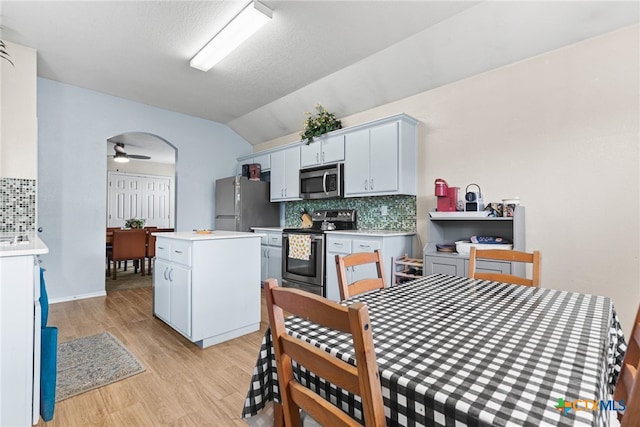 kitchen with white cabinetry, a center island, ceiling fan, and stainless steel appliances