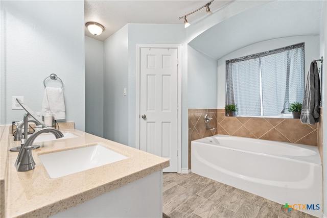 bathroom featuring hardwood / wood-style floors, vanity, and a bathtub