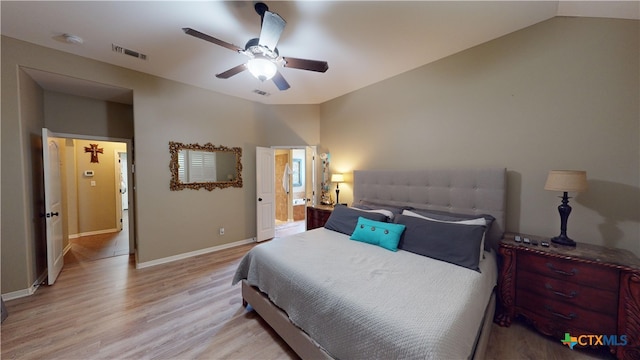 bedroom with ceiling fan, light hardwood / wood-style floors, and vaulted ceiling