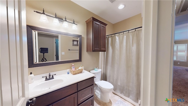 bathroom featuring tile patterned floors, vanity, toilet, and walk in shower