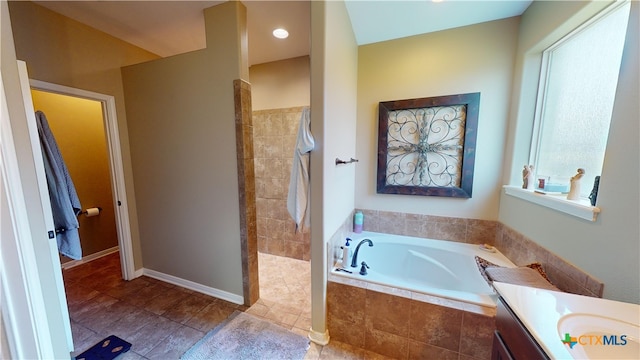 bathroom with vanity and independent shower and bath