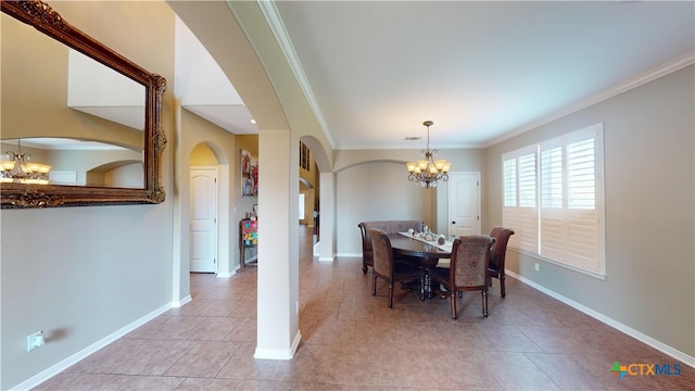 dining room with light tile patterned flooring, crown molding, and a chandelier